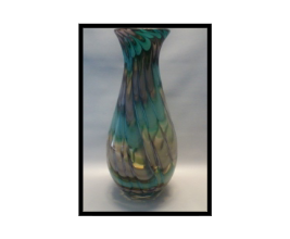 A vase with blue and green swirls on it.